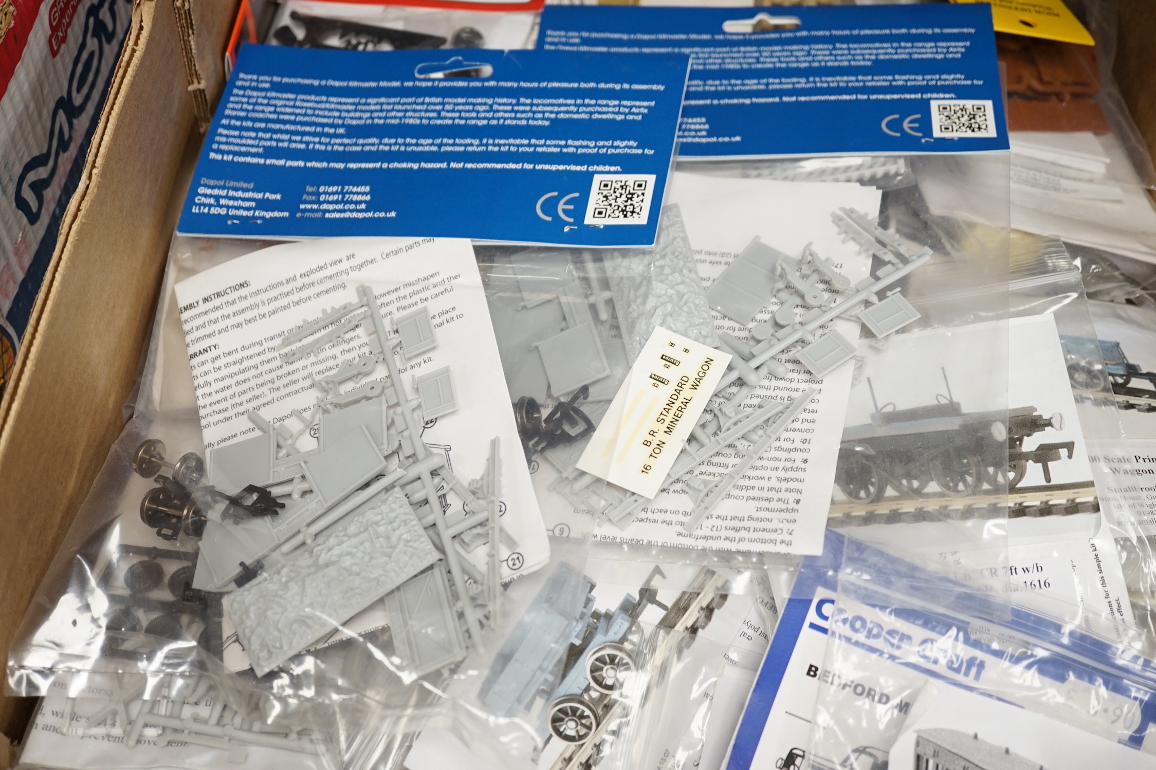 A collection of unmade, 4mm scale 00 gauge model, railway kits, and lineside accessories, including freight wagons, four-wheel coaches, commercial vehicles, etc. by Dapol, Cooper Craft, Parkside Dundas, etc. together wit